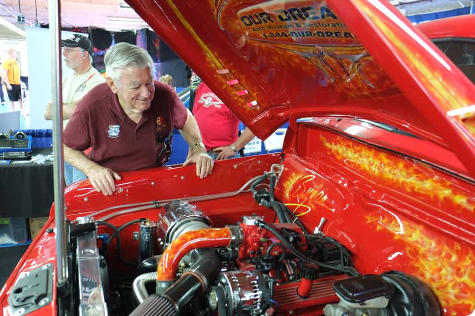 Stock car racing superstar Bobby Allison checks an engine