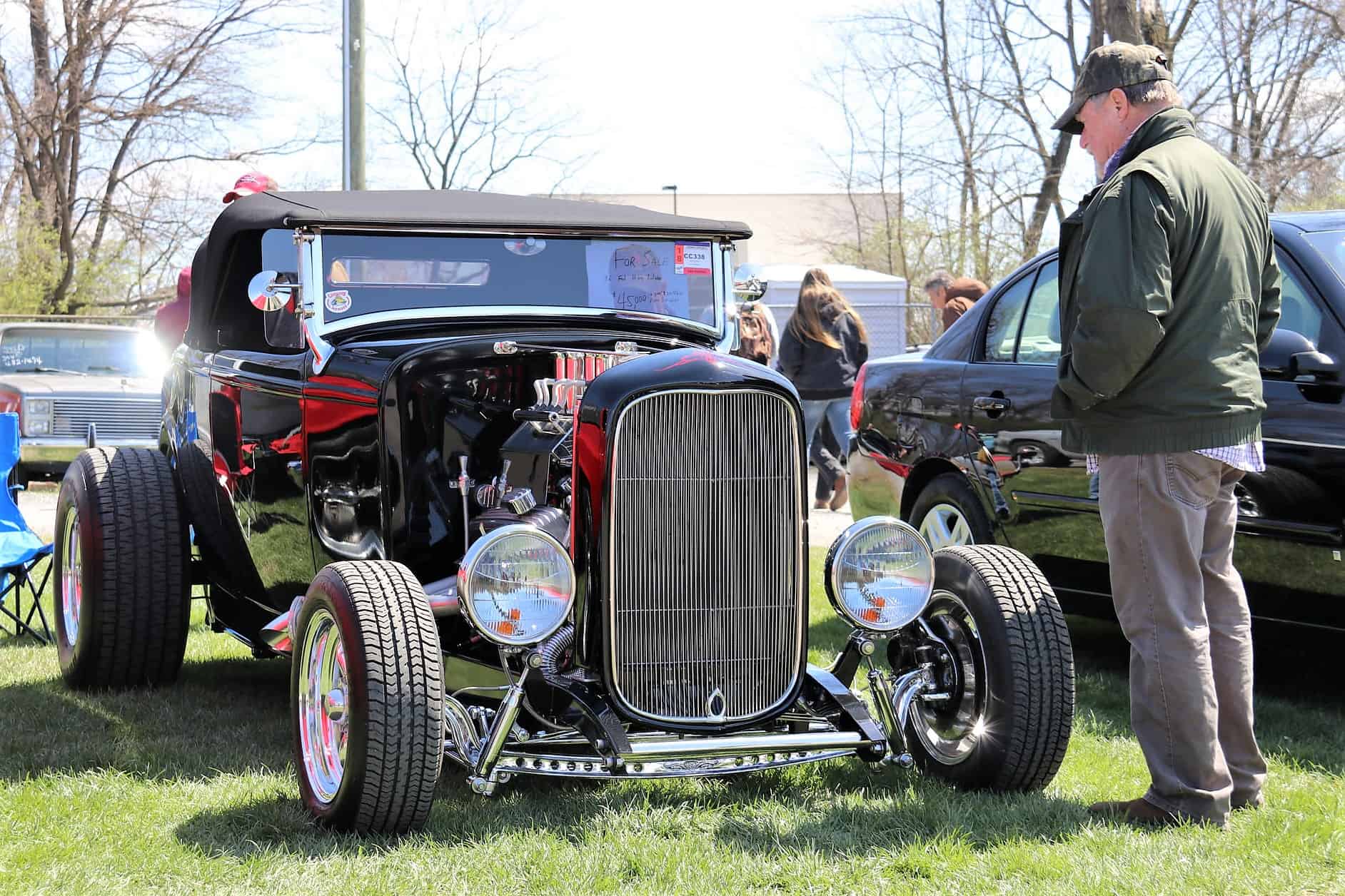 A prospective buyer studies a Ford hot rod at Spring Carlisle | Carlisle Events