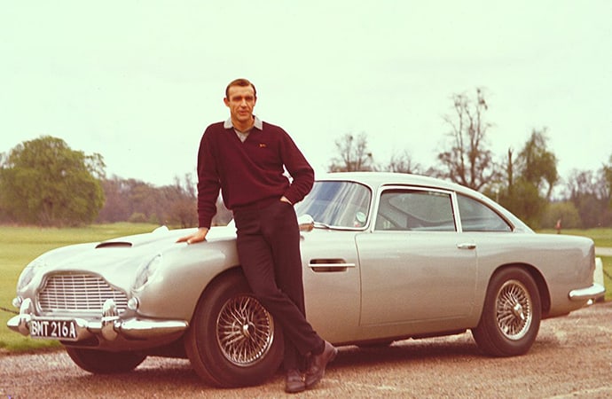 Actor Sean Connery, who played James Bond, stands near one of the Aston Martin DB5s used in the film Goldfinger. The film's primary car, chassis DP/216/1, was stolen in 1997 but may have been found in the Middle East. | Facebook photo
