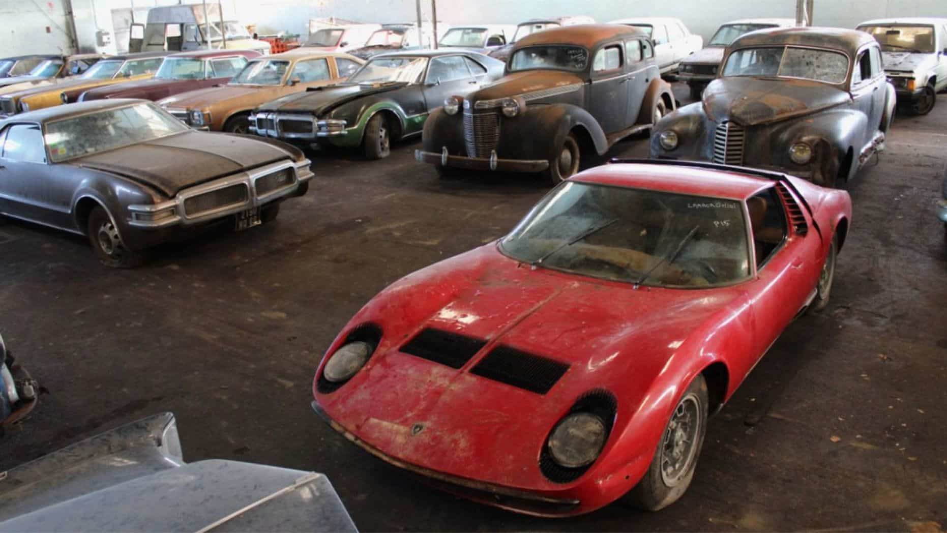 After French collector's death, more than 80 cars were discovered in buildings and outdoors, including a Lamborghini Miura. The big barn find will be offered at auction. | Interencheres photo