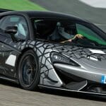 Silver-and-black-2021-McLaren-620R-driving-on-a-racetrack_o