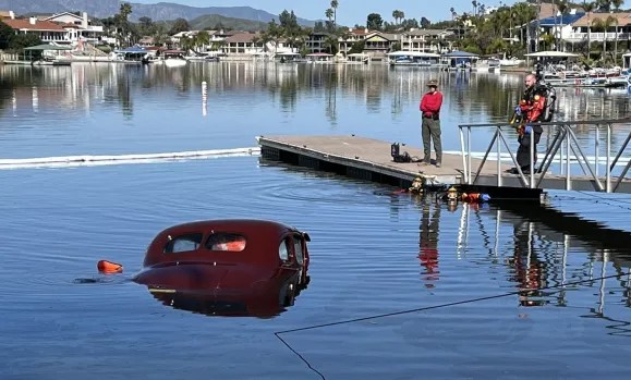 Man Watches Classic Car Sink in Lake